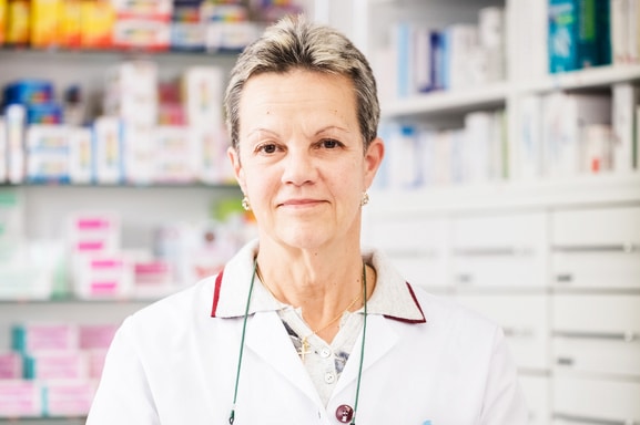 Female pharmacist looking ahead with a smile