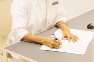 Close-up of pharmacist taking notes