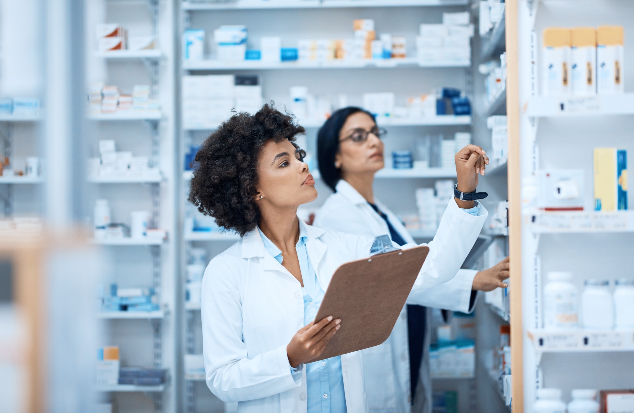 Two pharmacists doing inventory in a pharmacy