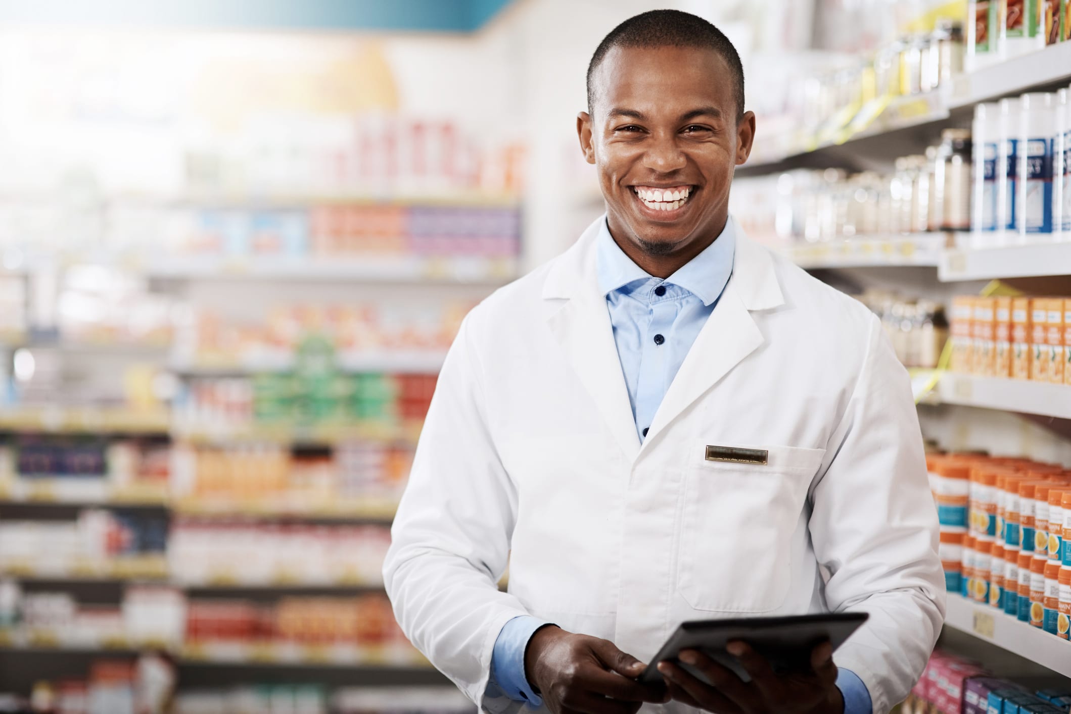 Portrait of a pharmacist standing and smiling at camera in a pharmacy