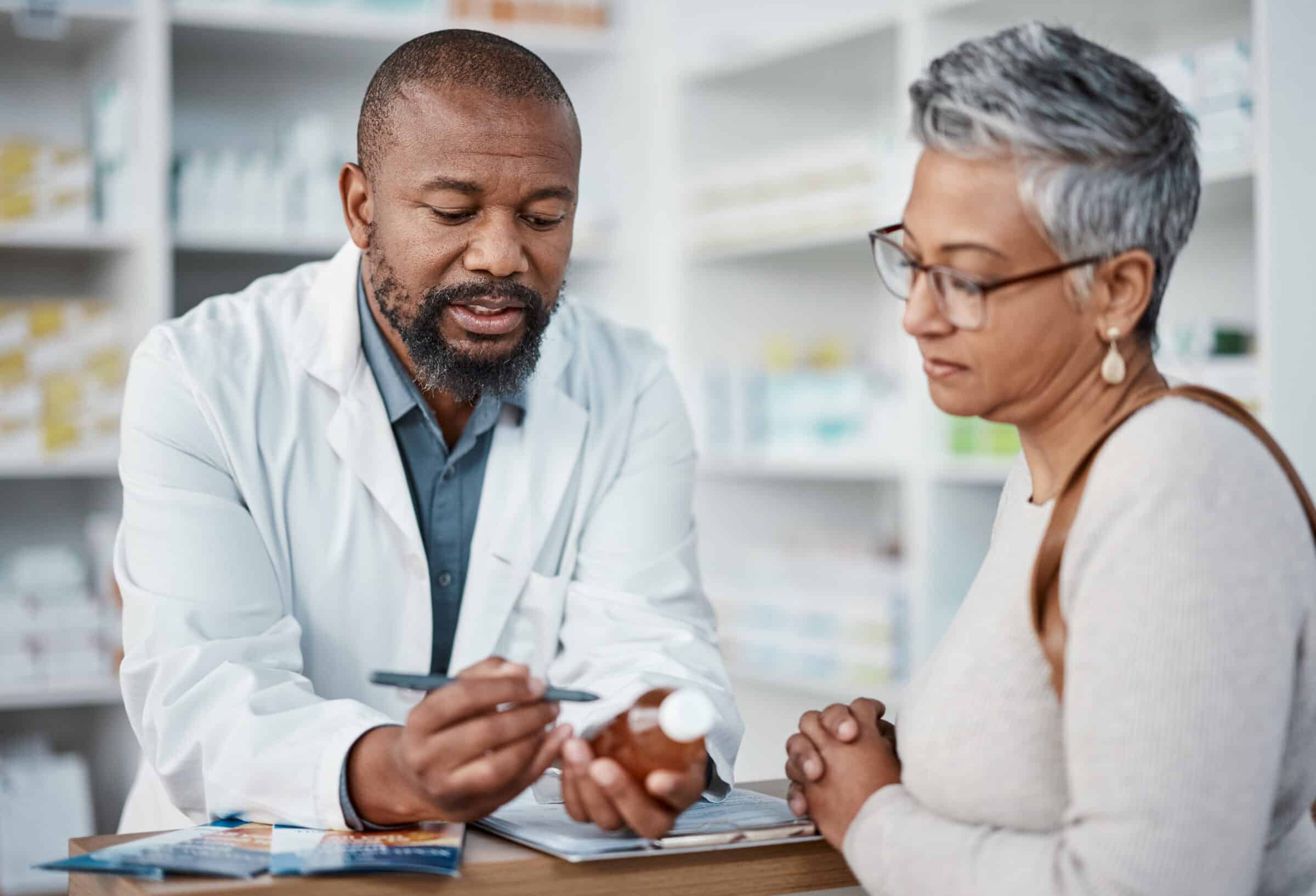 A pharmacist talking to a client about their prescription.