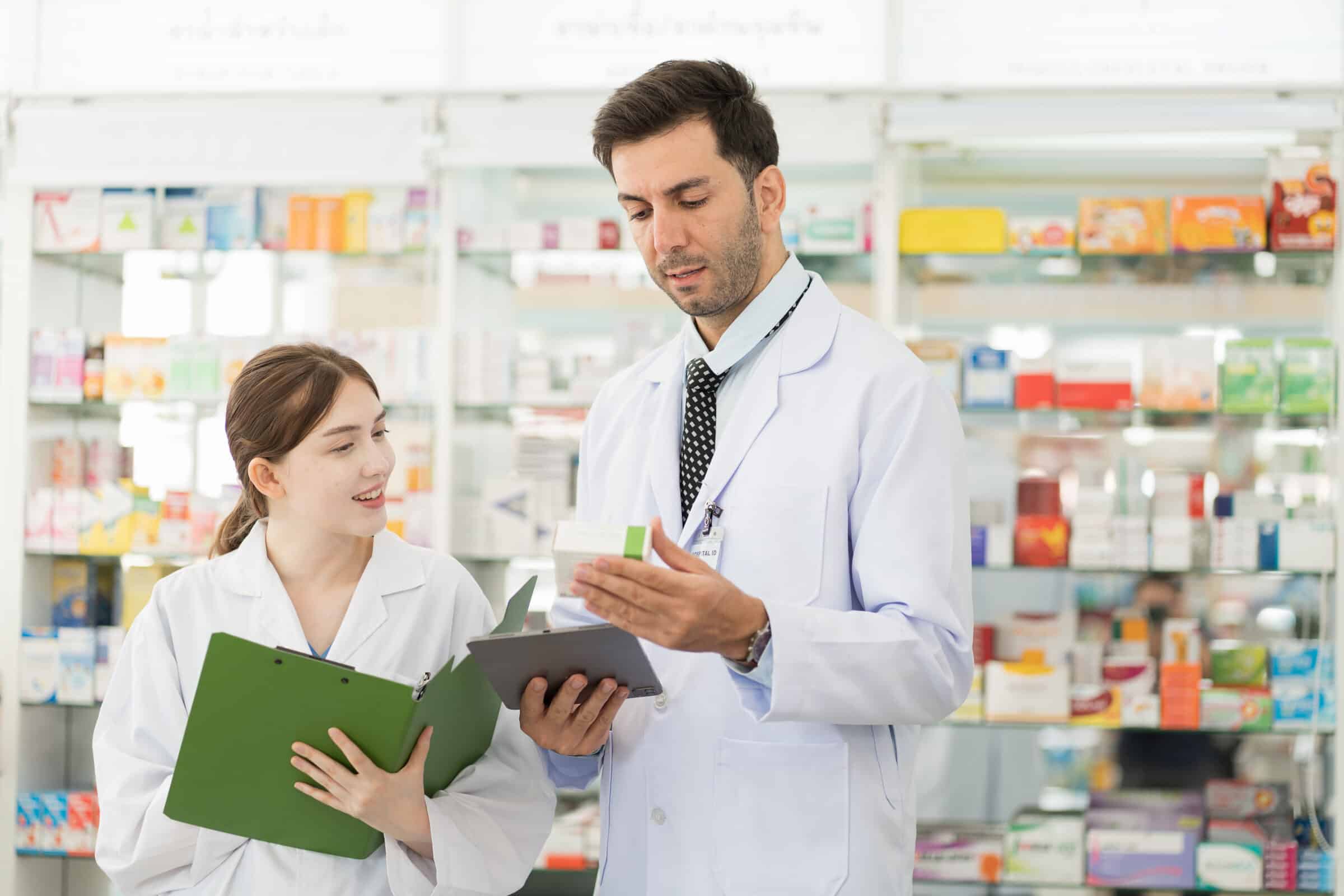 Pharmacist and pharmacy technician talking about a medication.